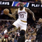 Cleveland Cavaliers' LeBron James (23) looks to pass against the Phoenix Suns during the first half of an NBA basketball game Wednesday, Jan. 27, 2016, in Cleveland. Suns' P.J. Tucker (17) watches. (AP Photo/Tony Dejak)
