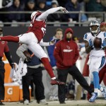 Carolina Panthers' Ted Ginn catches a pass in front of Arizona Cardinals' Jerraud Powers during the second half the NFL football NFC Championship game Sunday, Jan. 24, 2016, in Charlotte, N.C. (AP Photo/Chuck Burton)