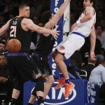 New York Knicks guard Sasha Vujacic (18) passes the ball off behind his back against Phoenix Suns center Alex Len (21) and guard Devin Booker during the second quarter of an NBA basketball game Friday, Jan. 29, 2016, in New York. (AP Photo/Julie Jacobson)