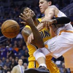 Phoenix Suns' Devin Booker, right, fouls Indiana Pacers' Paul George as George tries to shoot during the second half of an NBA basketball game Tuesday, Jan. 19, 2016, in Phoenix.  The Pacers defeated the Suns 97-94. (AP Photo/Ross D. Franklin)