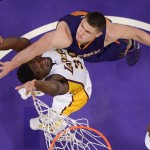 Los Angeles Lakers forward Julius Randle, left, and Phoenix Suns center Alex Len, of Ukraine, reach for a rebound during the first half of an NBA basketball game, Sunday, Jan. 3, 2016, in Los Angeles. (AP Photo/Mark J. Terrill)