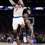 New York Knicks forward Carmelo Anthony (7) shoots in front of Phoenix Suns forward P.J. Tucker during the third quarter of an NBA basketball game Friday, Jan. 29, 2016, in New York. The Knicks won 102-84. (AP Photo/Julie Jacobson)
