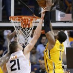 Phoenix Suns' Alex Len (21), of Ukraine, blocks a dunk attempt by Indiana Pacers' C.J. Miles (0) during the second half of an NBA basketball game Tuesday, Jan. 19, 2016, in Phoenix. The Pacers defeated the Suns 97-94. (AP Photo/Ross D. Franklin)
