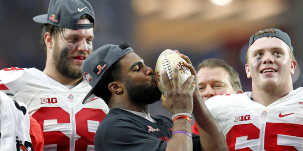 Ohio State running back Ezekiel Elliott kisses the trophy after their 44-28 win over Notre Dame in ...