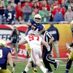 Notre Dame quarterback DeShone Kizer (14) throws a pass Ohio State defensive lineman Joey Bosa (97) leans in for a hit during the first half of the Fiesta Bowl NCAA College football game, Friday, Jan. 1, 2016, in Glendale, Ariz. Bosa was called for targeting on the hit and was ejected from the game. (AP Photo/Ross D. Franklin)