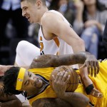 Phoenix Suns' Alex Len, top, of Ukraine, and Indiana Pacers' Jordan Hill vie for a loose ball during the second half of an NBA basketball game Tuesday, Jan. 19, 2016, in Phoenix. The Pacers defeated the Suns 97-94. (AP Photo/Ross D. Franklin)