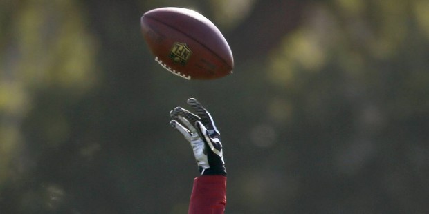 Arizona Cardinals' Patrick Peterson tosses the football back to a coach during NFL football practic...