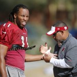 Arizona Cardinals' Larry Fitzgerald gets taped up at the start of NFL football practice at Cardinals training facility Wednesday, Jan. 20, 2016, in Tempe, Ariz.  The Cardinals will face the Carolina Panthers in the NFC Championship game on Sunday. (AP Photo/Ross D. Franklin)