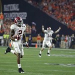 Alabama's Jake Coker (14) reacts as Derrick Henry (2) runs to the end zone during the first half of the NCAA college football playoff championship game Monday, Jan. 11, 2016, in Glendale, Ariz. (AP Photo/Chris Carlson)