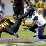Arizona State wide receiver Devin Lucien (15) is hit by West Virginia safety Dravon Askew-Henry (6) during the second half of the Cactus Bowl NCAA college football game, Saturday, Jan. 2, 2016, in Phoenix. (AP Photo/Ross D. Franklin)