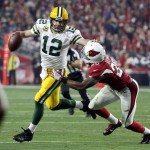 Green Bay Packers quarterback Aaron Rodgers (12) is hurried by Arizona Cardinals cornerback Justin Bethel (28) during the first half of an NFL divisional playoff football game, Saturday, Jan. 16, 2016, in Glendale, Ariz. (AP Photo/Ross D. Franklin)