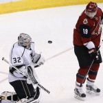 Los Angeles Kings' Jonathan Quick (32) makes a save behind Arizona Coyotes' Shane Doan (19) during the second period of an NHL hockey game Saturday, Jan. 23, 2016, in Glendale, Ariz. (AP Photo/Ross D. Franklin)