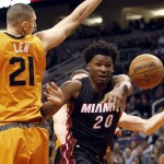 Miami Heat forward Justise Winslow (20) passes the ball as Phoenix Suns center Alex Len defends during the second quarter of an NBA basketball game Friday, Jan. 8, 2016, in Phoenix. (AP Photo/Rick Scuteri)