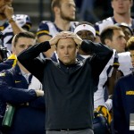West Virginia coach Dana Holgorsen watches during the first half of the Cactus Bowl NCAA college football game against Arizona State, Saturday, Jan. 2, 2016, in Phoenix. (AP Photo/Ross D. Franklin)