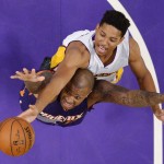 Phoenix Suns forward P.J. Tucker, below, and Los Angeles Lakers forward Anthony Brown reach for a rebound during the first half of an NBA basketball game Sunday, Jan. 3, 2016, in Los Angeles. (AP Photo/Mark J. Terrill)