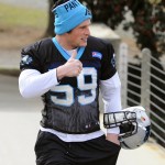 Carolina Panthers' Luke Kuechly (59) gives a thumbs-up to fans as he walks to NFL football practice in Charlotte, N.C., as the team prepares for the NFC Championship game against the Arizona Cardinals, Wednesday, Jan. 20, 2016. (David Foster IIICharlotte Observer via AP)