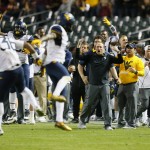 West Virginia head coach Dana Holgorsen, center, and his players celebrate a fourth down stop against Arizona State during the second half of the Cactus Bowl NCAA college football game, Sunday, Jan. 3, 2016, in Phoenix. West Virginia won 43-42. (AP Photo/Matt York)