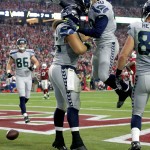 Seattle Seahawks fullback Will Tukuafu (46) celebrates with teammate Derrick Coleman (40) after scoring a touchdown against the Arizona Cardinals during the first half of an NFL football game, Sunday, Jan. 3, 2016, in Glendale, Ariz. (AP Photo/Ross D. Franklin)