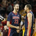 Arizona's Mark Tollefsen (23) celebrates with teammate Ryan Anderson, center, after making a basket off an offensive rebound during the second half of an NCAA college basketball game against Arizona State, Sunday, Jan. 3, 2016, in Tempe, Ariz. (AP Photo/Ralph Freso)