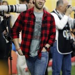 Baseball player Bryce Harper walks the sidelines prior to the Fiesta Bowl NCAA College football game between Ohio State and Notre Dame, Friday, Jan. 1, 2016, in Glendale, Ariz.  (AP Photo/Ross D. Franklin)