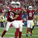 Arizona Cardinals wide receiver Michael Floyd (15) celebrates his touchdown catch with Jaron Brown (13) against the Green Bay Packers during the second half of an NFL divisional playoff football game, Saturday, Jan. 16, 2016, in Glendale, Ariz. (AP Photo/Ross D. Franklin)