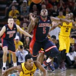 Arizona's Kadeem Allen (5) steals the basketball from Arizona State's Tra Holder, bottom, during the second half of an NCAA college basketball game, Sunday, Jan. 3, 2016, in Tempe, Ariz. (AP Photo/Ralph Freso)
