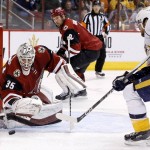 Arizona Coyotes' Louis Domingue (35) makes a save on a shot by Nashville Predators' Mike Fisher, right, as Coyotes' Nicklas Grossmann (2), of Sweden, watches during the first period of an NHL hockey game Saturday, Jan. 9, 2016, in Glendale, Ariz. (AP Photo/Ross D. Franklin)