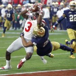 Ohio State wide receiver Michael Thomas (3) scores a touchdown has Notre Dame cornerback Nick Watkins (21) defends during the first half of the Fiesta Bowl NCAA College football game, Friday, Jan. 1, 2016, in Glendale, Ariz.  (AP Photo/Rick Scuteri)