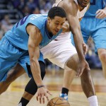 Charlotte Hornets' Brian Roberts, left, tries to drive past Phoenix Suns' T.J. Warren, right, as Warren reaches in vain for the ball during the first half of an NBA basketball game Wednesday, Jan. 6, 2016, in Phoenix. (AP Photo/Ross D. Franklin)