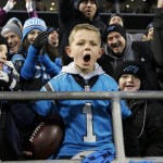 Seven-year-old Cameron Gandy celebrates after Carolina Panthers' Cam Newton gave him a touchdown ball during the first half the NFL football NFC Championship game against the Arizona Cardinals, Sunday, Jan. 24, 2016, in Charlotte, N.C. (AP Photo/Bob Leverone)