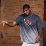 Arizona Cardinals' Calais Campbell waves to reporters as he arrives for a news conference at the NFL football team's training facility Wednesday, Jan. 20, 2016, in Tempe, Ariz. The Cardinals are scheduled to face the Carolina Panthers in the NFC championship game Sunday in Charlotte. (AP Photo/Ross D. Franklin)