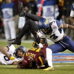 Arizona State wide receiver Devin Lucien (15) is hit by West Virginia safety Dravon Askew-Henry (6) and cornerback Ricky Rumph (3) during the first half of the Cactus Bowl NCAA college football game, Saturday, Jan. 2, 2016, in Phoenix. (AP Photo/Matt York)