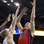 Arizona center Kaleb Tarczewski, right, shoots as UCLA center Thomas Welsh defends during the first half of an NCAA college basketball game Thursday, Jan. 7, 2016, in Los Angeles. (AP Photo/Mark J. Terrill)