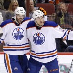 Edmonton Oilers' Leon Draisaitl, right, celebrates his goal against the Arizona Coyotes with Benoit Pouliot during the first period of an NHL hockey game Tuesday, Jan. 12, 2016, in Glendale, Ariz. (AP Photo/Ross D. Franklin)