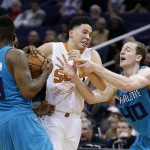 Phoenix Suns' Devin Booker, middle, loses the ball to Charlotte Hornets' P.J. Hairston (19) as Hornets' Cody Zeller (40) defends during the second half of an NBA basketball game, Wednesday, Jan. 6, 2016, in Phoenix.  A timeout was called prior to the strip and the Suns defeated the Hornets 111-102. (AP Photo/Ross D. Franklin)