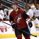 Arizona Coyotes' Antoine Vermette smiles after teammate Tobias Rieder scored an empty-net goal against the Nashville Predators during the third period of an NHL hockey game Saturday, Jan. 9, 2016, in Glendale, Ariz. Vermette scored his 200th NHL goal during the game, and the Coyotes defeated the Predators 4-0. (AP Photo/Ross D. Franklin)