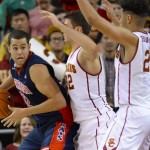 Arizona forward Ryan Anderson (12) looks for the open man as he is double-teamed by Southern California forward Nikola Jovanovic (32) and forward Bennie Boatwright (25) during the second half of an NCAA college basketball game, Saturday, Jan. 9, 2016, in Los Angeles. Southern California won it in a fourth overtime 103-101. (AP Photo/Gus Ruelas)