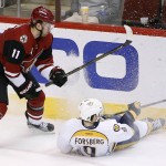 Nashville Predators' Filip Forsberg, right, of Sweden, falls to the ice in front of Arizona Coyotes' Martin Hanzal (11), of the Czech Republic, during the second period of an NHL hockey game Saturday, Jan. 9, 2016, in Glendale, Ariz. (AP Photo/Ross D. Franklin)