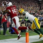 Arizona Cardinals wide receiver Michael Floyd (15) pulls in a touchdown pass as Green Bay Packers strong safety Morgan Burnett (42) defends during the first half of an NFL divisional playoff football game, Saturday, Jan. 16, 2016, in Glendale, Ariz. (AP Photo/Ross D. Franklin)