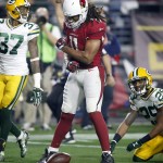 Arizona Cardinals wide receiver Larry Fitzgerald (11) celebrate his catch as Green Bay Packers cornerback Casey Hayward (29) and cornerback Sam Shields (37) look on during the second half of an NFL divisional playoff football game, Saturday, Jan. 16, 2016, in Glendale, Ariz. (AP Photo/Rick Scuteri)