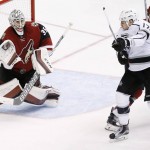 Arizona Coyotes' Louis Domingue (35) makes a save on a shot as Los Angeles Kings' Milan Lucic (17) raises his stick in an attempt to redirect the puck as Coyotes' Michael Stone (26) defends during the third period of an NHL hockey game Saturday, Jan. 23, 2016, in Glendale, Ariz.  The Coyotes defeated the Kings 3-2. (AP Photo/Ross D. Franklin)