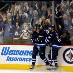 Winnipeg Jets' Dustin Byfuglien (33) and Andrew Ladd (16) celebrate after Byfuglien scored his second goal of the night against the Arizona Coyotes, during the second period of an NHL hockey game Tuesday, Jan 26, 2016, in Winnipeg, Manitoba. (Trevor Hagan/The Canadian Press via AP)