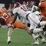 Alabama's Reuben Foster tackles Clemson's Hunter Renfrow (13) during the first half of the NCAA college football playoff championship game Monday, Jan. 11, 2016, in Glendale, Ariz. (AP Photo/Chris Carlson)