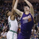 Phoenix Suns forward Mirza Teletovic (35) shoots past Boston Celtics guard Marcus Smart during the second half of an NBA basketball game Friday, Jan. 15, 2016, in Boston. The Celtics defeated the Suns 117-103. (AP Photo/Stephan Savoia)