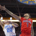 UCLA guard Bryce Alford, left, shoots as Arizona guard Gabe York defends during the first half of an NCAA college basketball game, Thursday, Jan. 7, 2016, in Los Angeles. (AP Photo/Mark J. Terrill)