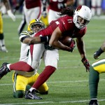 Arizona Cardinals wide receiver Larry Fitzgerald (11) is stopped by Green Bay Packers cornerback Damarious Randall (23) during the second half of an NFL divisional playoff football game, Saturday, Jan. 16, 2016, in Glendale, Ariz. (AP Photo/Ross D. Franklin)