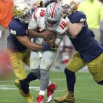 Ohio State quarterback J.T. Barrett (16) is sacked by Notre Dame linebacker James Onwualu, left, and defensive lineman Andrew Trumbetti during the second half of the Fiesta Bowl NCAA College football game, Friday, Jan. 1, 2016, in Glendale, Ariz.  (AP Photo/Rick Scuteri)