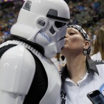 Sonya Hopkins of Arlington, Texas, kisses her husband Josh, who's dressed in a Stars Wars themed costume before an NBA basketball game between the Phoenix Suns and Dallas Mavericks on Sunday, Jan. 31, 2016, in Dallas. Josh other persons dressed in costume participated in pre game activities as the Mavericks celebrated Star Wars night at the game. (AP Photo/Tony Gutierrez)