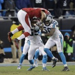Arizona Cardinals' Darren Fells is hit by Carolina Panthers' Thomas Davis (58) and Luke Kuechly after catching a pass during the first half the NFL football NFC Championship game Sunday, Jan. 24, 2016, in Charlotte, N.C. (AP Photo/David J. Phillip)