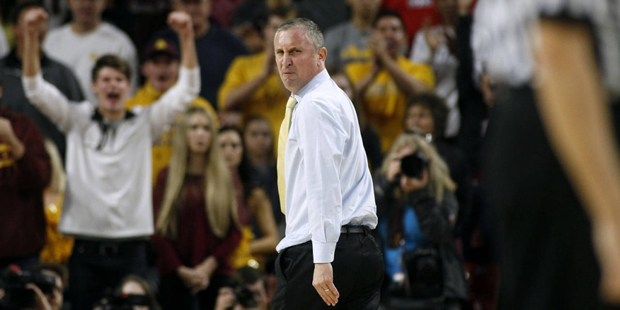 Arizona State head coach Bobby Hurley glares back at an official as he walks off the court after be...